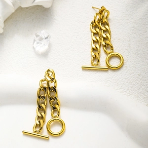 Detail shot of golden stainless steel earrings with OT buckle and chic chain link design