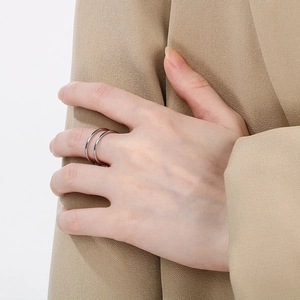 Detail of minimalist double-layer stainless steel open ring worn on a finger
