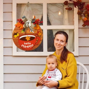Autumn harvest round wooden door sign with hello pumpkin text and maple leaves