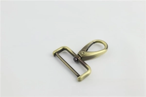 Detail view of vintage bronze swivel lobster clasp for bag straps and hardware
