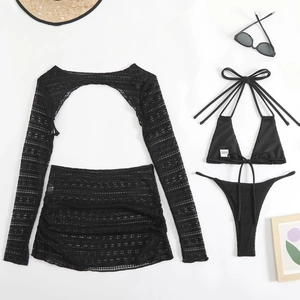 Detail of a four-piece black lace bikini set with sheer cover-up and sunglasses