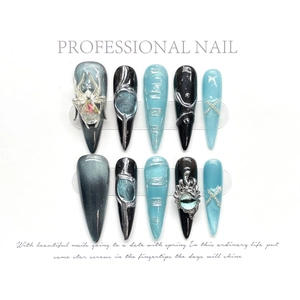 Long stiletto press-on nails featuring black cat-eye finish with silver spider and eye charms