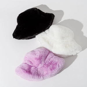 Three plush faux fur bucket hats in black, white, and lilac showing thick warm textures