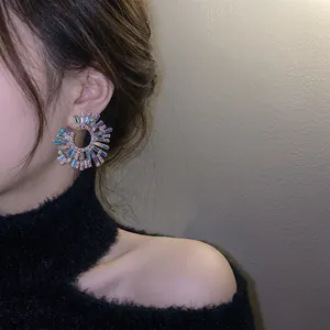 Exaggerated iridescent blue earrings with radial design and sparkling zircon stones