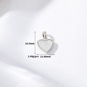 Macro shot of 14K gold plated heart pendant with white shell and size 16.5mm measurements