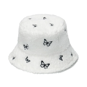 White faux fur bucket hat featuring embroidered black butterflies for autumn winter style