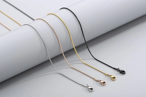 Detail of round snake chains in silver, rose gold, gold, and black with lobster clasps
