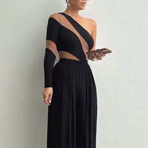 Detail of sheer mesh patchwork and one-shoulder design on a black bodycon bodysuit