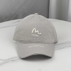Detailed shot of grey cotton baseball cap with white 3D embroidery and distressed brim