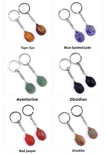 Detailed grid of crystal gemstone hand grenade keychains in various natural stones