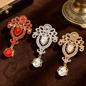 Detail of vintage baroque crystal necklaces with intricate metalwork on brown velvet