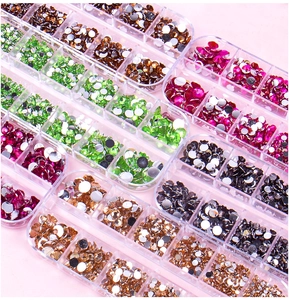 Detailed view of colorful flatback acrylic rhinestones organized in 12-slot clear storage boxes
