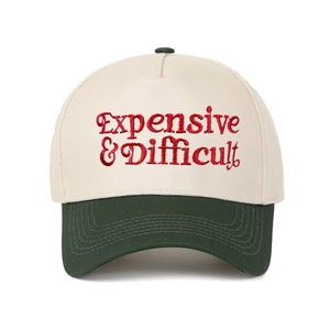 Detail of red 3D embroidery text on cream and green two-tone twill cotton baseball cap