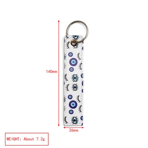 Detailed view of evil eye faux leather keychain showing dimensions 140mm by 26mm in size