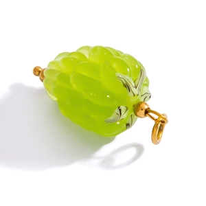 Detail of light green glass fruit pendant with 18k gold-plated stainless steel loop