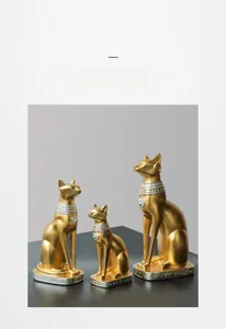 Vista dettagliata di tre statue di gatti Bastet dorati con basi in argento incise a mano