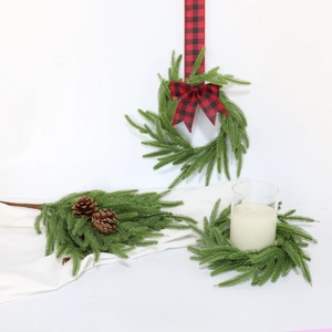 Artificial Norfolk Pine wreath and cedar branches with pine cones and plaid ribbons