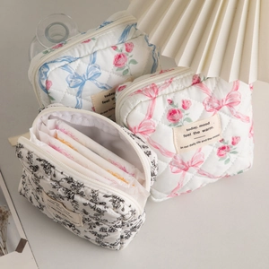 Quilted floral makeup bag showing interior storage for feminine care and daily essentials
