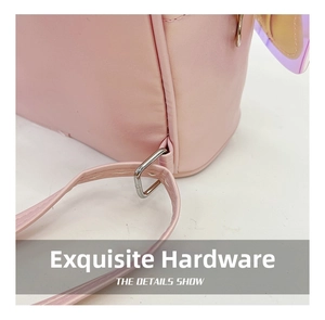 Detail of silver D-ring metal buckle and pink leather shoulder strap on girl's backpack