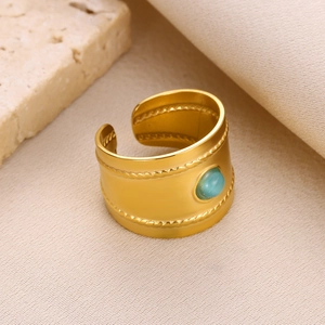 Macro detail of gold vintage ring featuring inlaid turquoise and twisted rope border