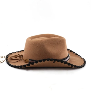 Detail of brown western cowboy hat with woven edge and decorative leather band