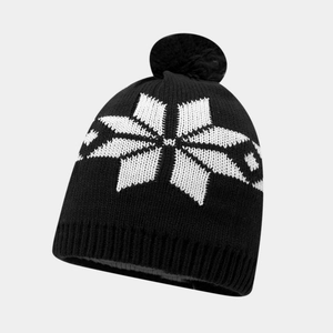 Close-up of black knit beanie featuring white snowflake patterns and a soft pom-pom top