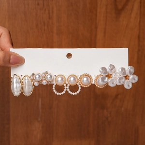 Detail of 6-pair pearl earring set featuring floral and oval designs on gold-tone bases