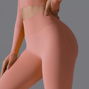 Detail view of pink coral seamless high waist yoga leggings with ribbed waistband texture