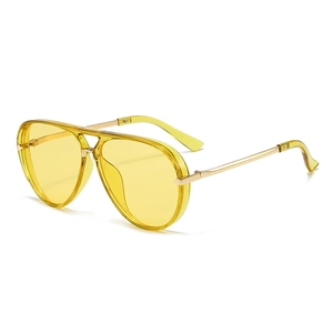 Detail view of aviator sunglasses featuring yellow lenses and a gold metal frame
