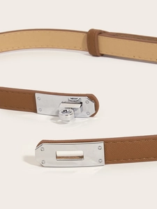 Close-up of caramel brown leather slim belt featuring a silver-tone metal twist lock
