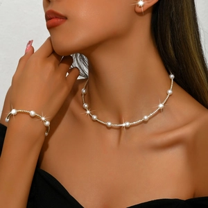 Detailed view of pearl and rhinestone choker necklace with matching gold-tone jewelry set