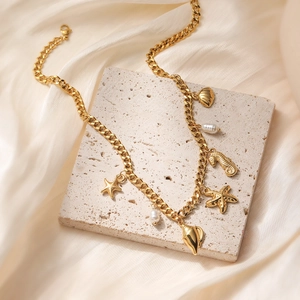 18K gold plated stainless steel necklace with starfish, shell and pearl charms on stone