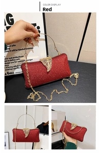 Detail of red glitter evening clutch with golden leaf clasp and metal ring handle