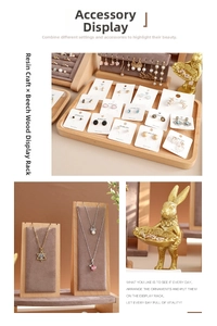 Detail of wooden jewelry display stands with velvet lining and gold bunny tray