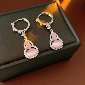 Pink opal gourd earrings with zircon accents in silver setting on black leather background
