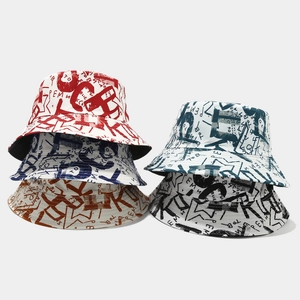 Detailed close-up of reversible graffiti bucket hats in multiple vibrant tie-dye colorways