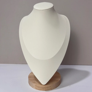 Detail of minimalist beech wood necklace bust stand with premium cream faux leather surface