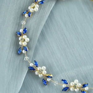 Detailed view of bridal hair vine with blue marquise rhinestones and white pearls