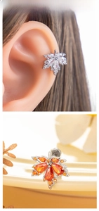 Detailed close-up of maple leaf stud earrings with sparkling cubic zirconia inlay work