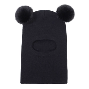 Detail view of black knit balaclava for kids with two pom-poms and warm ear protection