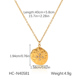 Detail view of 18K gold star pendant necklace with dimensions and hammered texture