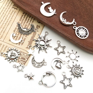 Detail of vintage silver moon sun and star alloy pendants for DIY jewelry making
