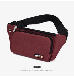 Detail view of burgundy oxford fabric waist bag with durable zippers and earphone port