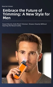 Close-up of orange electric nose hair trimmer with LED screen held by a man