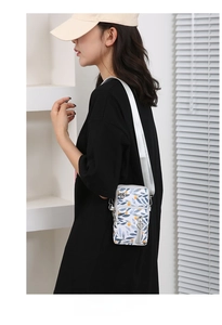 Detail of white Oxford fabric phone bag with blue and orange leaf print and wide strap