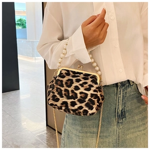 Detail of trendy leopard print handbag featuring elegant pearl handle and gold chain strap