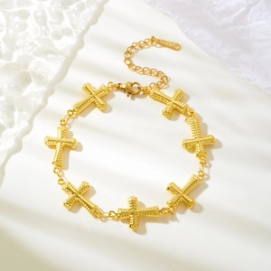 Minimalist gold stainless steel cross bracelet with textured links and lobster clasp