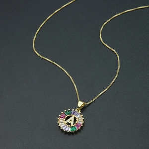 Detailed shot of letter A pendant with colorful zircon stones on a gold chain necklace