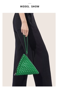 Detail of green triangle woven handbag featuring leather Intrecciato craft and silver zipper