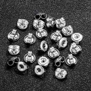 Silver stainless steel butterfly earring backs and disk stoppers on black texture